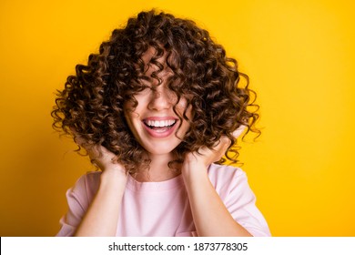 Photo portrait of girl with curly hairstyle wearing t-shirt laughing touching hair isolated on bright yellow color background - Shutterstock ID 1873778305