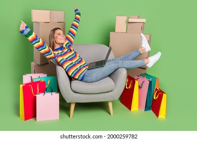 Photo portrait girl happy overjoyed doing online shopping sitting in chair isolated pastel green color background
