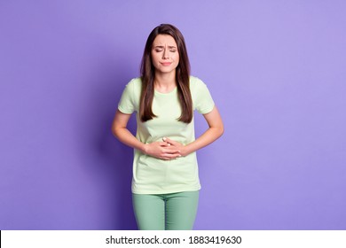 Photo Portrait Of Girl Holding Hands On Tummy Suffering Stomach Ache Pain Isolated On Bright Violet Color Background
