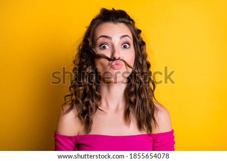 Photo portrait of girl making fake mustache pouting wearing pink crop-top isolated on vivid yellow colored background
