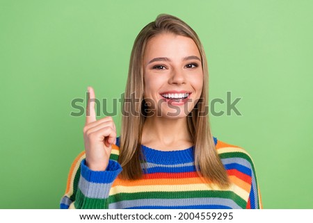 Photo portrait girl pointing up finger promoting remember isolated pastel green color background