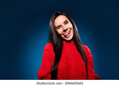 Photo portrait girl smiling winking licking lip wearing knitted red sweater isolated dark blue color background