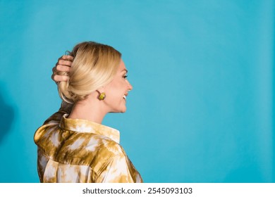 Photo portrait of gorgeous mature lady arrange hold hair dressed stylish formalwear clothes isolated on cyan color background - Powered by Shutterstock