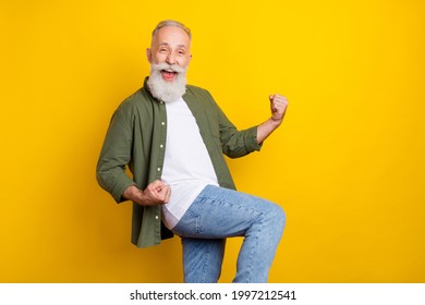 Photo portrait of grandfather smiling happy gesturing like winner isolated vivid yellow color background with copyspace