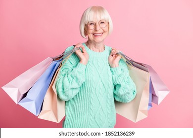 Photo Portrait Of Granny Carrying Bags After Black Friday Sale Wearing Glasses Isolated On Pastel Pink Color Background