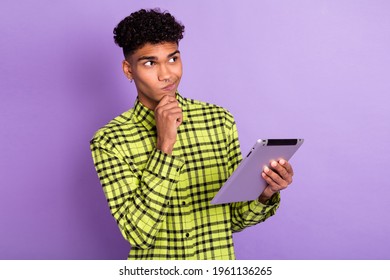 Photo Portrait Of Guy Thoughtful Looking Empty Space Keeping Tablet Reading Information Isolated On Pastel Purple Color Background