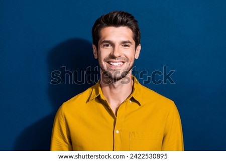 Photo portrait of handsome young guy cheerful toothy smile wear trendy yellow outfit isolated on dark blue color background