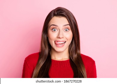 Photo portrait of happy funny girl with brunette hair showing tongue smiling fooling isolated on pink color background