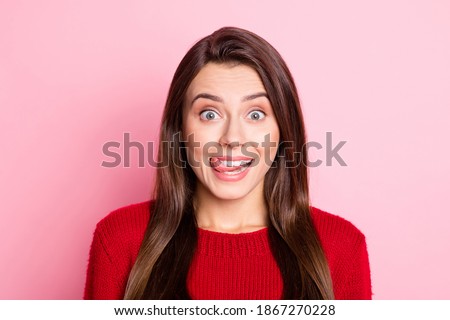 Photo portrait of happy funny girl with brunette hair showing tongue smiling fooling isolated on pink color background