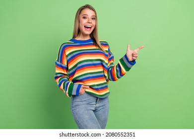 Photo portrait laughing girl wearing striped pullover showing blank space amazed isolated pastel green color background - Powered by Shutterstock