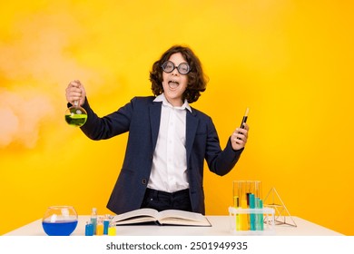 Photo portrait of little pupil boy chemistry experiment wear trendy uniform isolated on yellow color background - Powered by Shutterstock