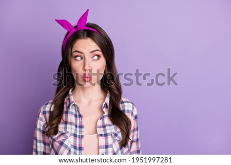 Photo portrait of lovely girl pouting looking at blank space isolated on vivid purple colored background