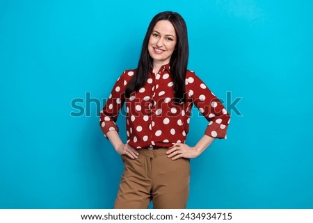 Photo portrait of lovely lady confident entrepreneur pose wear trendy dotted red garment isolated on blue color background