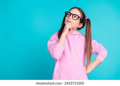 Photo portrait of lovely little girl look empty space minded dressed stylish pink garment isolated on aquamarine color background - Powered by Shutterstock