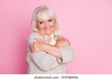 Photo portrait of lovely old lady isolated on pastel pink colored background with blank space