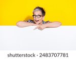 Photo portrait of lovely senior lady point down empty space dressed stylish colorful garment isolated on yellow color background