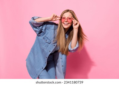 Photo portrait of lovely teen young lady disco dance summer shopping promo dressed stylish denim garment isolated on pink color background - Powered by Shutterstock