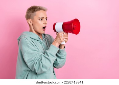 Photo portrait of lovely young lady hold loudspeaker scared shocked activist dressed stylish khaki outfit isolated on pink color background - Shutterstock ID 2282418841