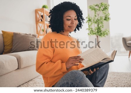 Photo portrait of lovely young lady sit floor read books dressed casual orange clothes cozy day light home interior living room