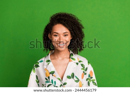 Photo portrait of lovely young lady toothy beaming smile wear trendy orange print garment isolated on green color background