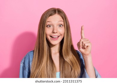 Photo portrait of lovely young teenager lady finger point up brilliant idea wear trendy jeans garment isolated on pink color background - Shutterstock ID 2311311375