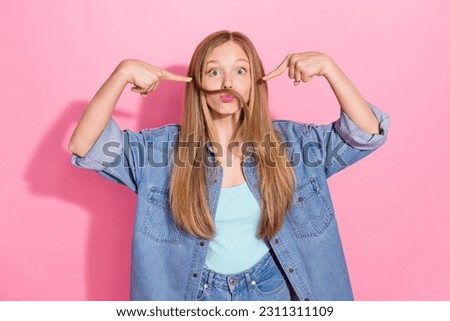 Photo portrait of lovely young teenager lady fingers point self fake mustache wear trendy jeans garment isolated on pink color background