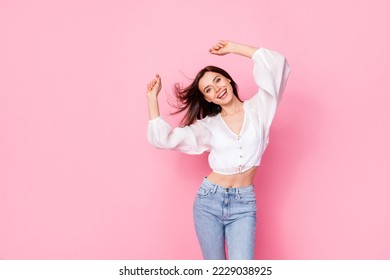 Photo portrait of lovely young woman dance raise hands party disco dieting wear trendy white garment isolated on pink color background - Powered by Shutterstock