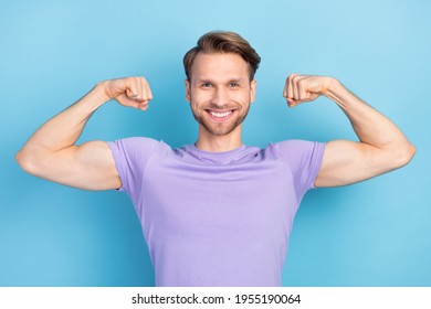 Photo portrait of man positive nice demonstrating strong biceps isolated on pastel blue color background - Shutterstock ID 1955190064