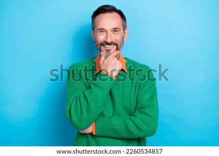 Photo portrait of mature handsome man touch chin create business strategy dressed stylish green clothes isolated on blue color background