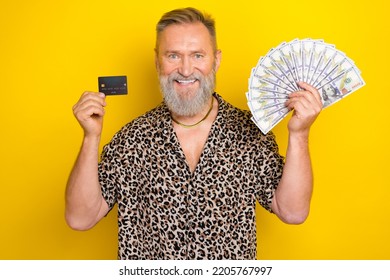 Photo Portrait Of Nice Grandpa Hold Money Fan Credit Card Bank Promo Dressed Stylish Leopard Print Look Isolated On Yellow Color Background