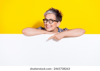 Photo portrait of nice pensioner female point down empty space wear trendy colorful outfit isolated on yellow color background - Powered by Shutterstock