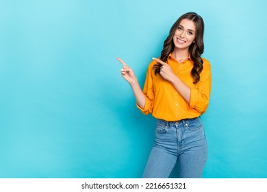 Photo Portrait Of Nice Young Lady Point Copyspace Service Promo Dressed Stylish Yellow Smart Casual Look Isolated On Blue Color Background