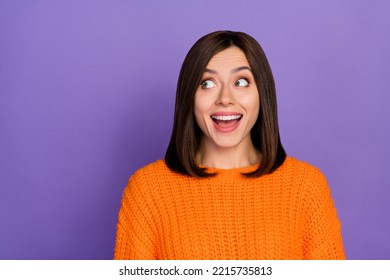 Photo Portrait Of Nice Young Woman Look Excited Empty Space Wear Trendy Knitwear Orange Garment Isolated On Violet Color Background