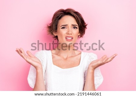 Photo portrait of nice young woman shrug shoulders do not know look camera dressed trendy white clothes isolated on pink color background