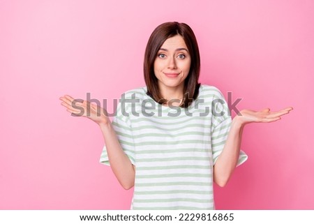 Photo portrait of nice young woman shrug shoulders make mistake sorry dressed stylish striped garment isolated on pink color background