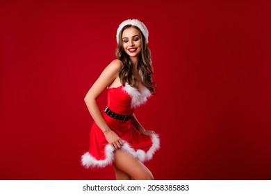 Photo Portrait Of Playful Woman In Short Christmas Dress Isolated On Vivid Red Colored Background