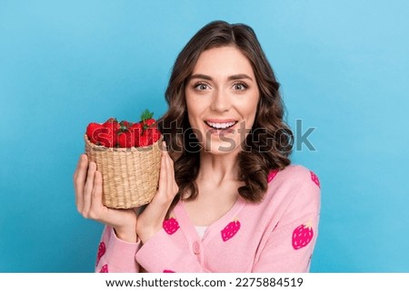 Photo portrait of pretty girl hold strawberry basket excited gardener dressed stylish pink print clothes isolated on blue color background