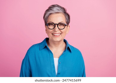 Photo portrait of pretty retired female look camera smile wear trendy blue outfit isolated on pink color background - Powered by Shutterstock