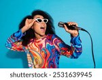 Photo portrait of pretty young girl sing karaoke microphone wear trendy colorful outfit isolated on blue color background