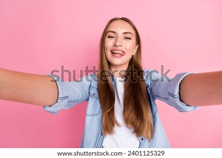 Photo portrait of pretty young girl video recording tongue out selfie dressed stylish denim outfit isolated on pink color background