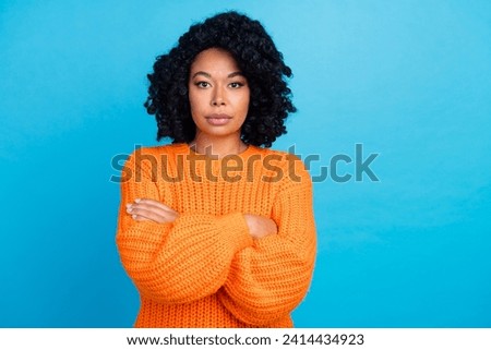 Photo portrait of pretty young girl crossed hands strict confident dressed stylish knitted orange outfit isolated on blue color background