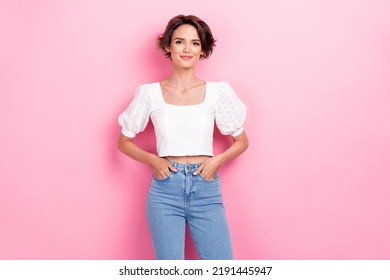 Photo portrait of pretty young lady posing hold hands pocket try on new jeans dressed trendy white outfit isolated on pink color background - Shutterstock ID 2191445947