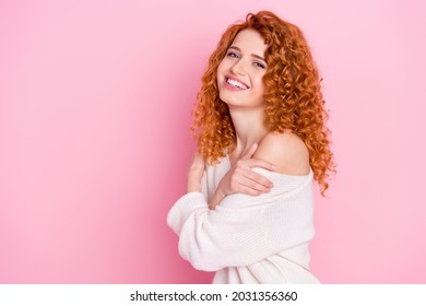 Photo portrait of red haired curly woman smiling laughing embracing herself isolated on pastel pink color background with copyspace