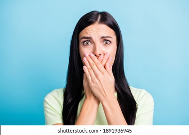 Photo portrait of scared woman covering mouth with two hands isolated on pastel blue colored background - Shutterstock ID 1891936945