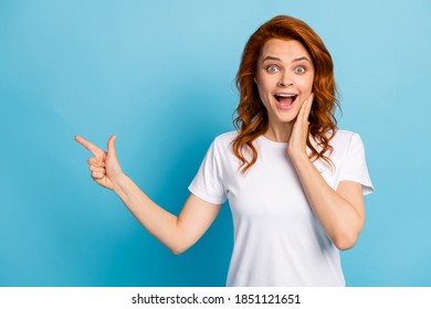 Photo portrait of shocked girl touching face cheek with hand pointing finger at blank space isolated on pastel blue colored background - Shutterstock ID 1851121651