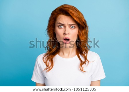 Photo portrait of shocked upset woman isolated on pastel blue colored background