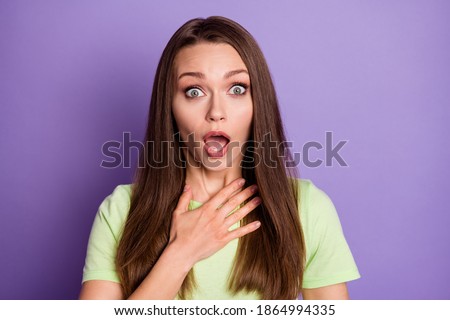 Photo portrait of shocked woman with open mouth touching chest with hand isolated on vivid violet colored background