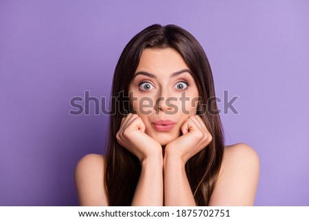 Photo portrait of silly pouting girl holding face chin with two hands isolated on vivid purple colored background