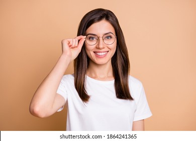 Photo portrait of smart girl wearing eyewear smiling in casual stylish outfit isolated pastel beige color background