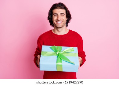 Photo Portrait Of Smiling Man Holding Present Box Isolated On Pastel Pink Colored Background